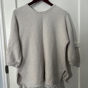 Wrap London Hally Knit Fringe Button Pullover Sweater in beige.